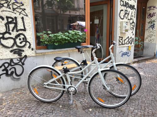 a white bike parked in front of a building at Minimal Hostel in Berlin
