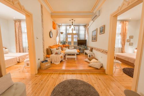 a living room with wooden floors and white walls at TOMOVI HOME - Three bedrooms City center in Plovdiv