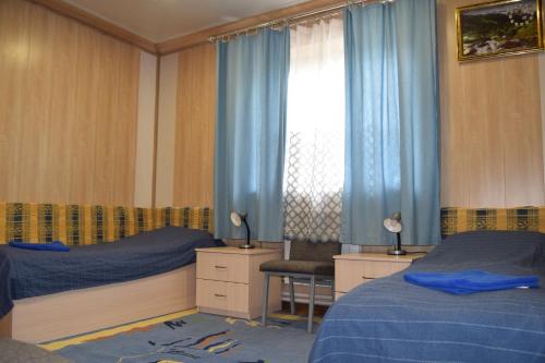En eller flere senge i et værelse på Гостевой дом Chimgan Apple Garden