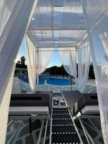 a view from the back of a boat with white curtains at Zoumis Residence in Naousa