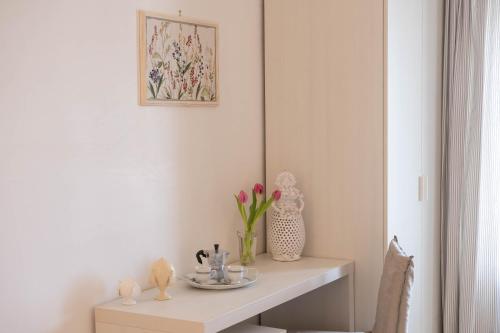 a table in a room with a vase of flowers at TERRA TERRA - Masseria Minunni in Conversano