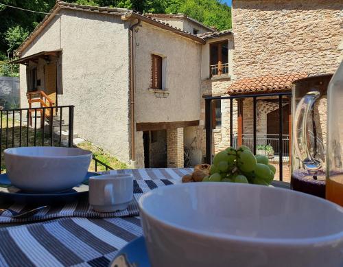 a table with bowls and plates of food on top of it at Agriturismo Cardella in Piobbico