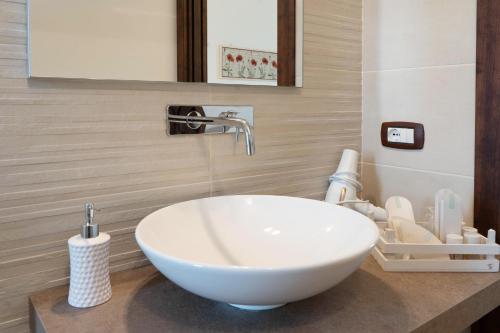 a bathroom with a white sink and a mirror at TERRA TERRA - Masseria Minunni in Conversano