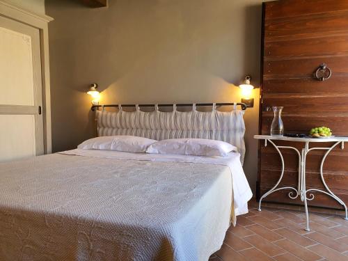 a bedroom with a bed and a side table at Agriturismo Cardella in Piobbico