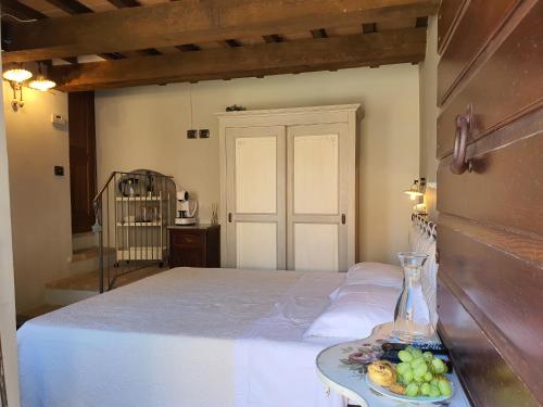 a bedroom with a bed with a plate of fruit on a tray at Agriturismo Cardella in Piobbico