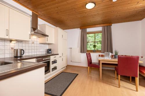 a kitchen and dining room with a table and chairs at Ferienhaus Anna in Zell am Ziller