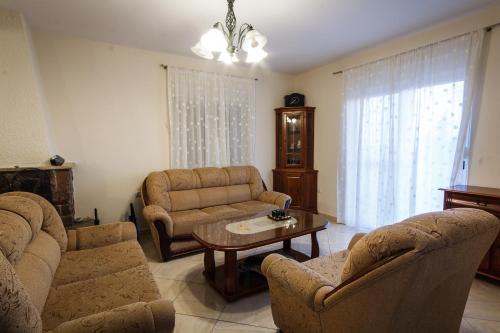 a living room with a couch and a table and chairs at Apartments Klara in Utjeha