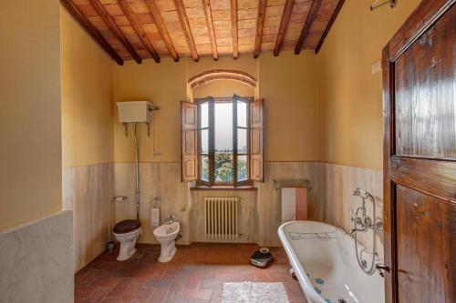 a bathroom with a tub and a toilet and a sink at Palazzo Luci in Colle di Val d'Elsa