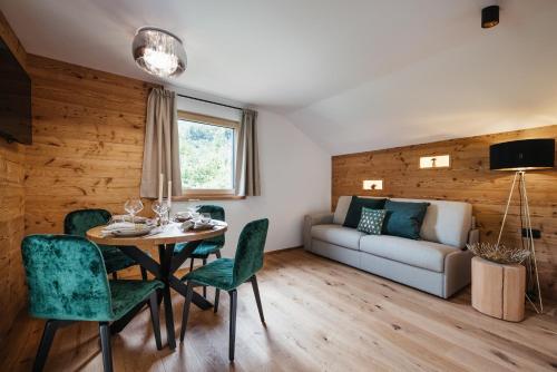 a living room with a table and chairs and a couch at Ludwig‘s Mountain Lodges in Dalaas