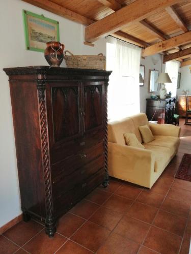 a couch and a cabinet in a living room at Agriturismo Il Casaletto in Montefranco