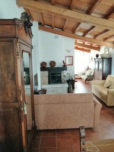 a living room with a couch and a fireplace at Agriturismo Il Casaletto in Montefranco