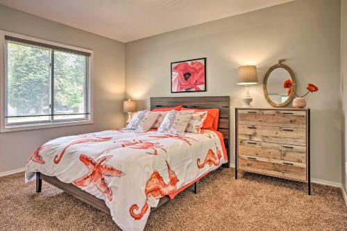 a bedroom with a large bed and a mirror at Chic Coos Bay Home with Pacific Ocean Views! in Coos Bay