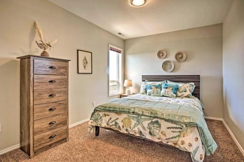 a bedroom with a large bed and a dresser at Chic Coos Bay Home with Pacific Ocean Views! in Coos Bay