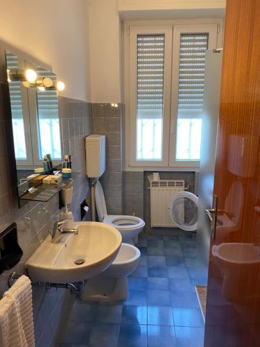 a bathroom with two toilets and a sink and mirror at Favolosa Vista Mare in Rimini