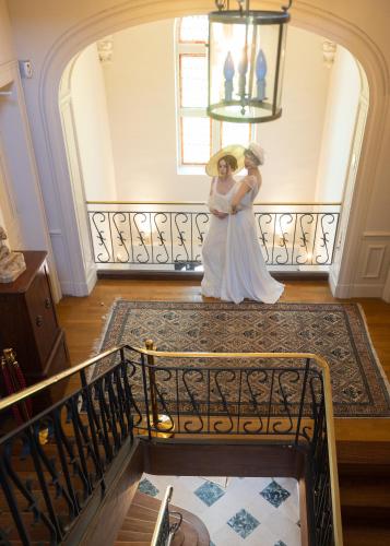 a bride and groom standing on a staircase at Château de la Bribourdière in Putot-en-Auge