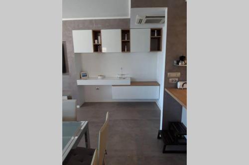 a small kitchen with white cabinets and a floor at For Families Only - Casa Nora Novigrad in Novigrad Istria