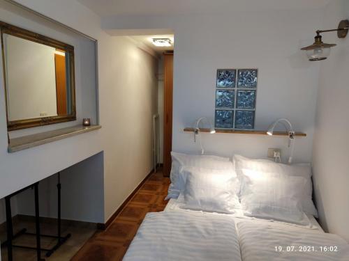 a bedroom with a bed and a mirror on the wall at SUMMER TIME in Premantura