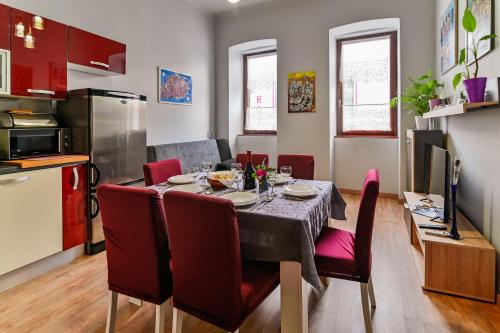 a kitchen and dining room with a table and chairs at Apartman Rene in Crikvenica