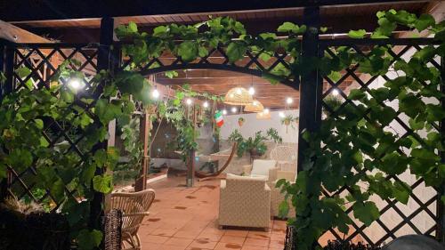 a pergola with a table and chairs in a garden at Alma Migrante bed&wine in Telese