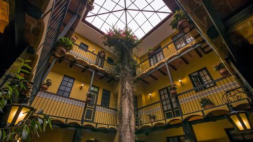 a building with a tree in the middle of it at Hotel Naira in La Paz