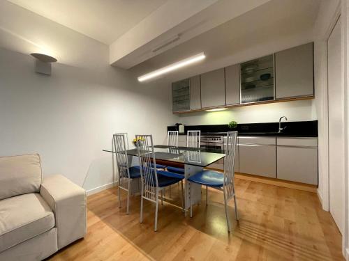 a kitchen with a table and chairs and a couch at Apartament Jurata 30 in Jurata