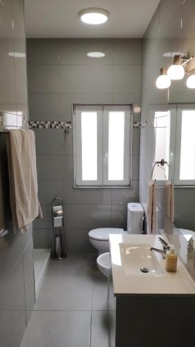 a bathroom with a sink and a toilet and a tub at Portela House - T3 Residential home 50 meters from the beach in Vila Praia de Âncora