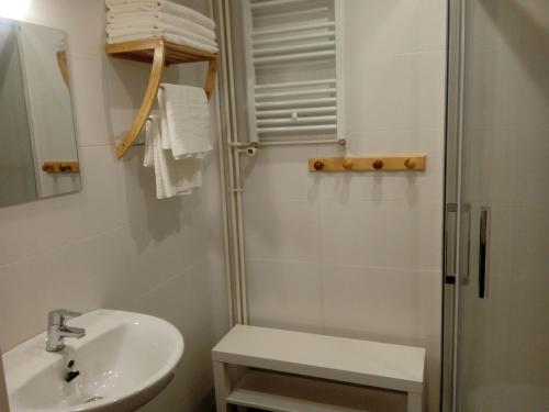 a white bathroom with a sink and a shower at Casa del Sol in Organyà