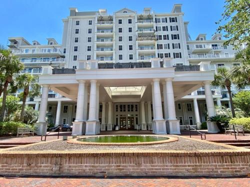 a large building with a fountain in front of it at Grand Sandestin at Sandestin Resort by Tufan in Destin