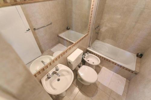 a bathroom with a sink and a toilet and a tub at La Sureña in San Rafael