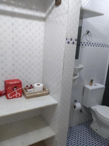 a white bathroom with a toilet and a sink at Pousada Refugio do Pirata in Trindade