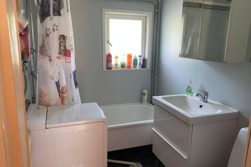 a bathroom with a sink and a tub and a shower at Summer in the North of Sweden in Bjurholm