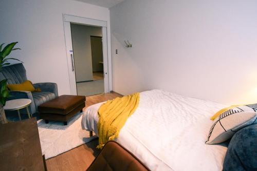 a bedroom with a bed and a living room at GATEWAY MAIZURU in Maizuru