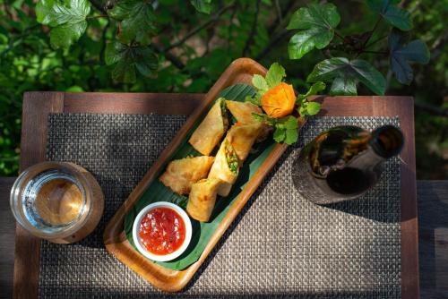 a tray of food on a table with a plate of food at The Seraya Resort Komodo in Labuan Bajo