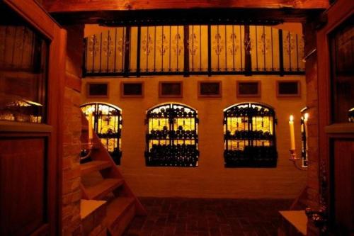 a room with a bunch of wine bottles on the wall at Skrøbelev Gods Manor House in Rudkøbing