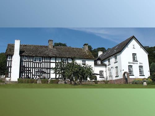 a white house with a black and white building at Rhydspence in Hay-on-Wye