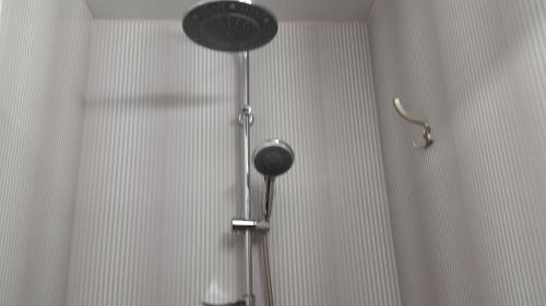 a shower in a bathroom with a shower curtain at Baltā in Ventspils