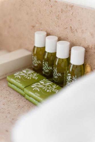 three bottles of essential oils sitting on a counter at Florand Rooms&Wine in Sopron