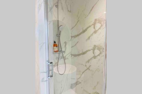 a bathroom with a shower with a toilet and a sink at L’adoré Sainte Catherine in Bordeaux