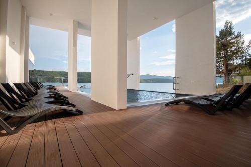 a row of chairs in a room with a view of the water at Hotel VAPORE in Neum
