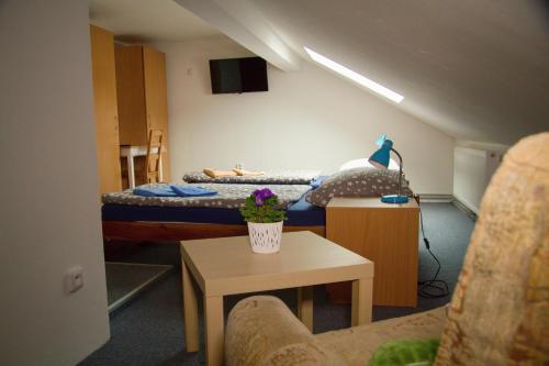 a small room with two beds and a table at Penzion 411 in Solnice