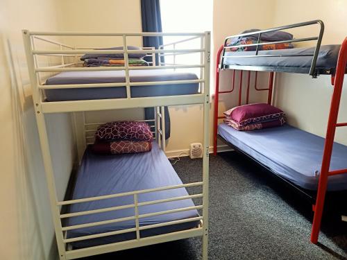 two bunk beds in a small room with at Wander Inn Bunbury in Bunbury