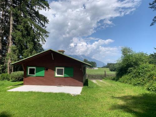 a small house in the middle of a field at Waldchalet am Eichhof in Innsbruck
