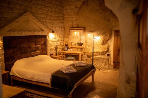 Ліжко або ліжка в номері Pome Granate Cave Hotel