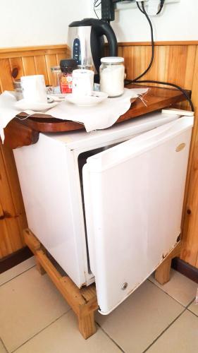 a microwave under a counter in a kitchen at Bernique Guesthouse in La Digue