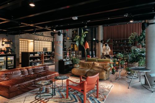 a store with leather couches and chairs in a room at Superbude Wien Prater in Vienna