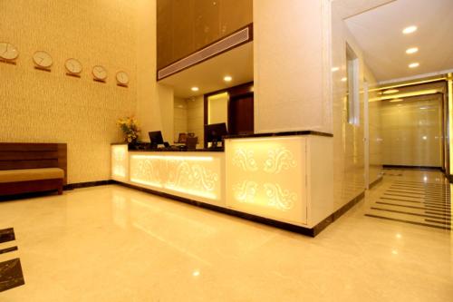 a lobby with a reception desk in a building at WEST FORT HOTEL in Bengaluru