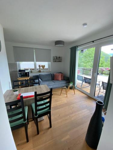 a living room with a table and a couch at Landhaus Zirben in Bad Kleinkirchheim