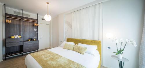 - une chambre avec un lit blanc et une table dans l'établissement Hotel Luna, à Marina di Massa