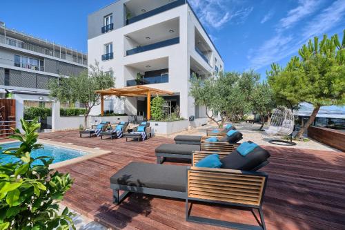 an outdoor patio with furniture and a swimming pool at Liberty Living Apartments in Split