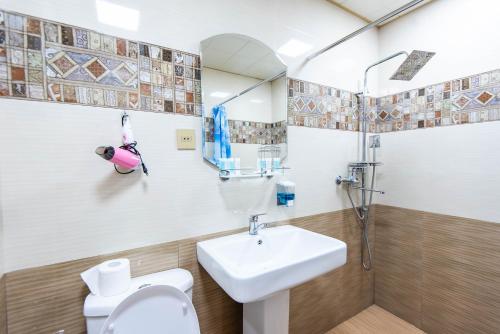 a bathroom with a sink and a toilet at Damla Hotel Baku in Baku